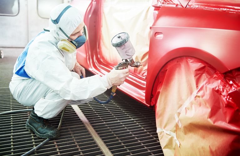 Service staff painting a vehicle